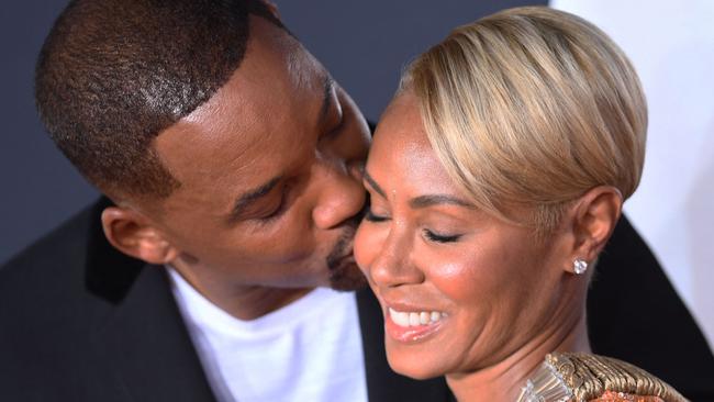 (FILES) US actor Will Smith (L) kisses actress Jada Pinkett Smith as they arrive for the premiere of 
