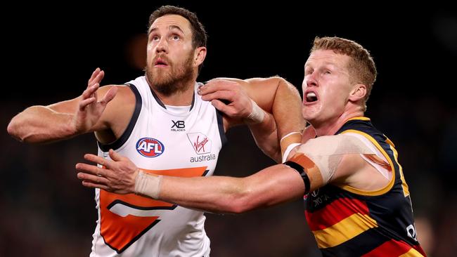 Reilly O’Brien had arguably the best game of his short career against Giants giant Shane Mumford on Saturday night. Picture: James Elsby/AFL Photos/Getty Images