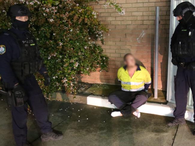 Fixated Persons Investigations Unit arrest pair over alleged car bombing and intimidation in Warrawong. Picture: NSW Police