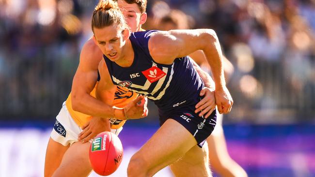 Nat Fyfe battles Jack Redden for the ball.