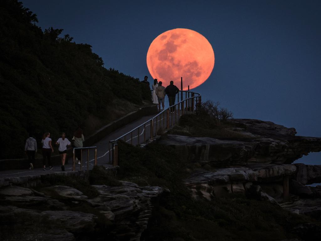 Sydneysiders were seen exercising under the orange moon. Picture: David Gray/AFP