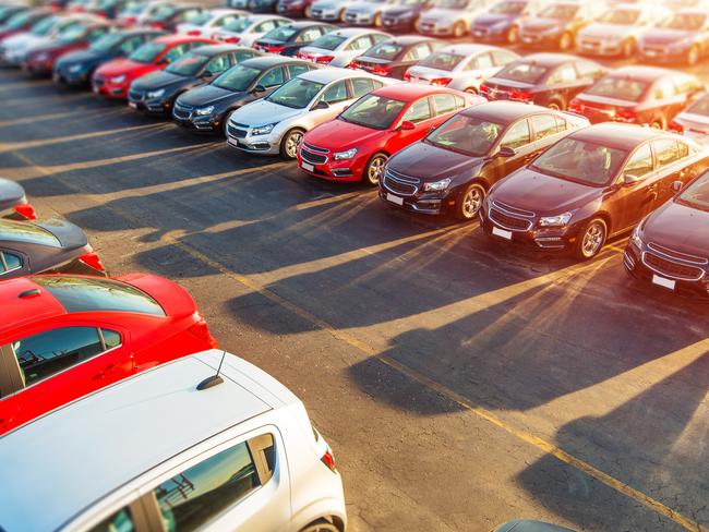 Dealer New Cars Stock. Colorful Brand New Compact Vehicles For Sale Awaiting on the Dealer Parking Lot. Car Market Business Concept.