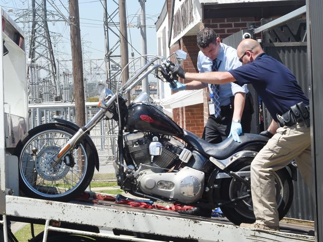 Police remove a motorcycle from Finks Ringwood club.