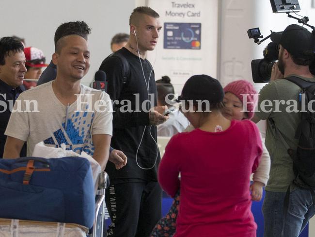 Dustin Martin steps off the plane to a media throng. Picture: Simon Runting