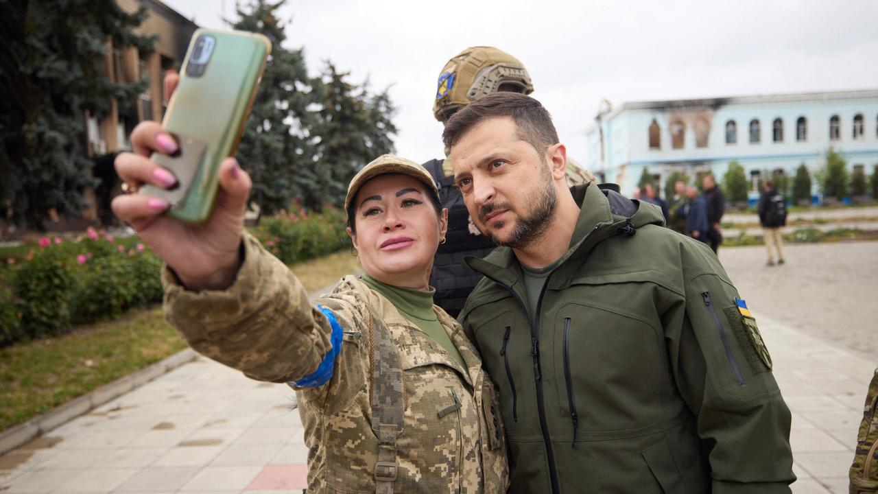 Volodymyr Zelensky posing for a photo with a servicewoman in the de-occupied city of Izyum, in the Kharkiv region, on Wednesday. Picture: Ukrainian Presidential Press Service / AFP