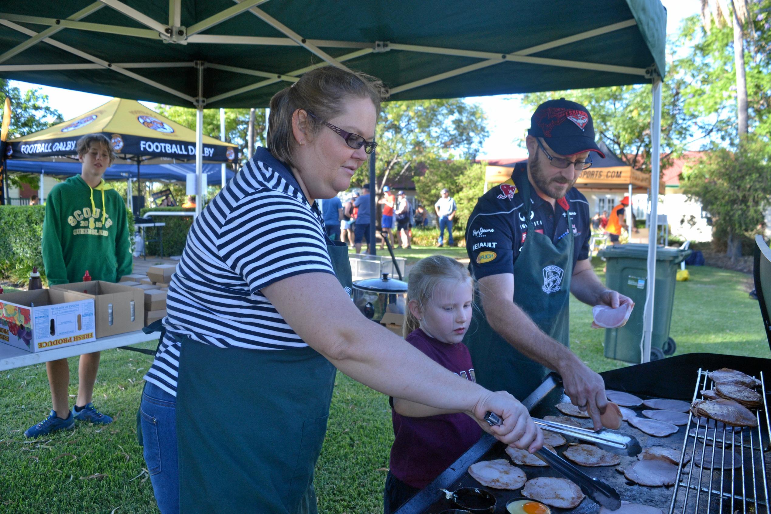 Jennifer Tunley, Anika Atkins and Brett Atkins manning the barbecue. Picture: Meg Gannon