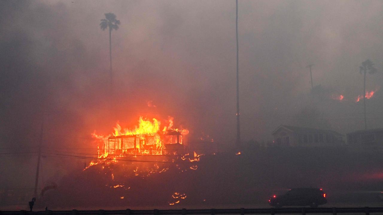 A ferocious wildfire in a Los Angeles suburb devoured buildings and sparked panicked evacuations. Picture: Robyn Beck / AFP