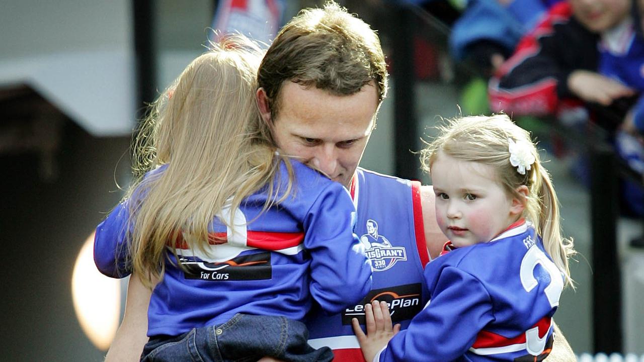 Chris Grant carries his daughters Isabella (left) and Sascha (right) before playing his 330th game and breaking the club record.