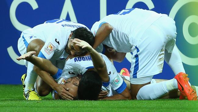 Vokhid Shodiev of Uzbekistan celebrates with teammates.