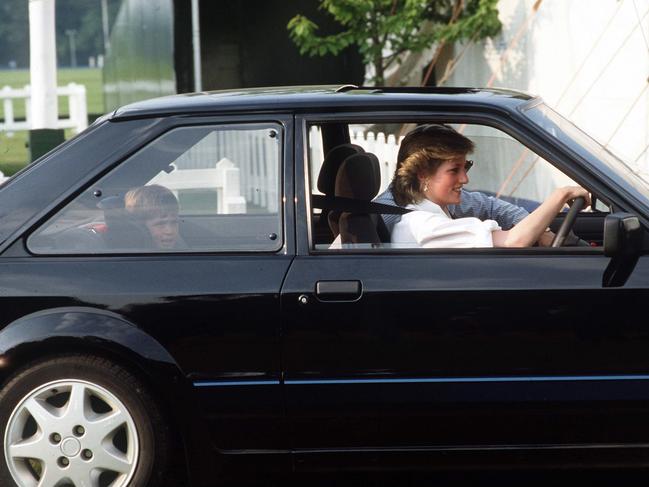 Princess Diana driving her Ford Escort with Prince William in the back seat. The car sold for $A1.1 million at auction. Picture: Getty Images