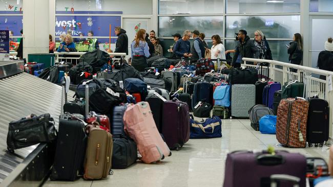 Stranded Southwest Airlines passengers looks for their luggage in the baggage claim area at Chicago Midway International Airport. Pictures: AFP