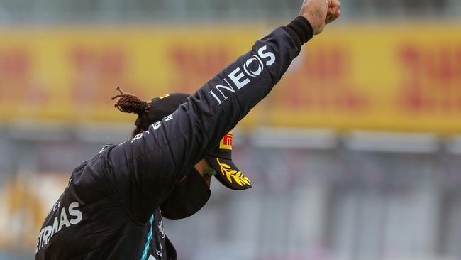 Mercedes driver Lewis Hamilton gives the Black Power salute on the podium.