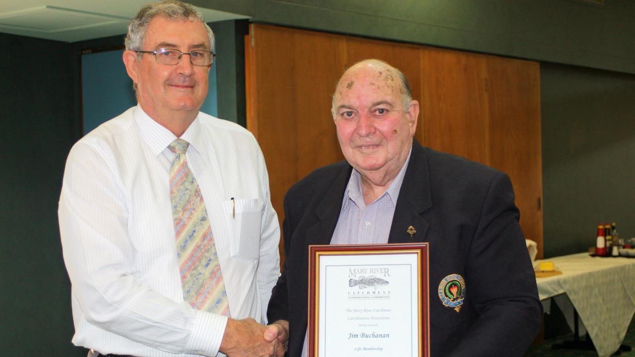 The late Gympie Regional Council mayor Ron Dyne presents Jim Buchanan with his MRCCC life membership.