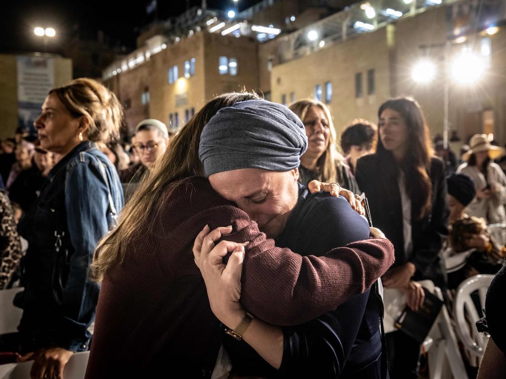 People react after lighting candles in memory of the 1400 victims killed during the October 7 attack by Palestinian militants from the Gaza Strip at the Western Wall in Jerusalem. Picture: AFP