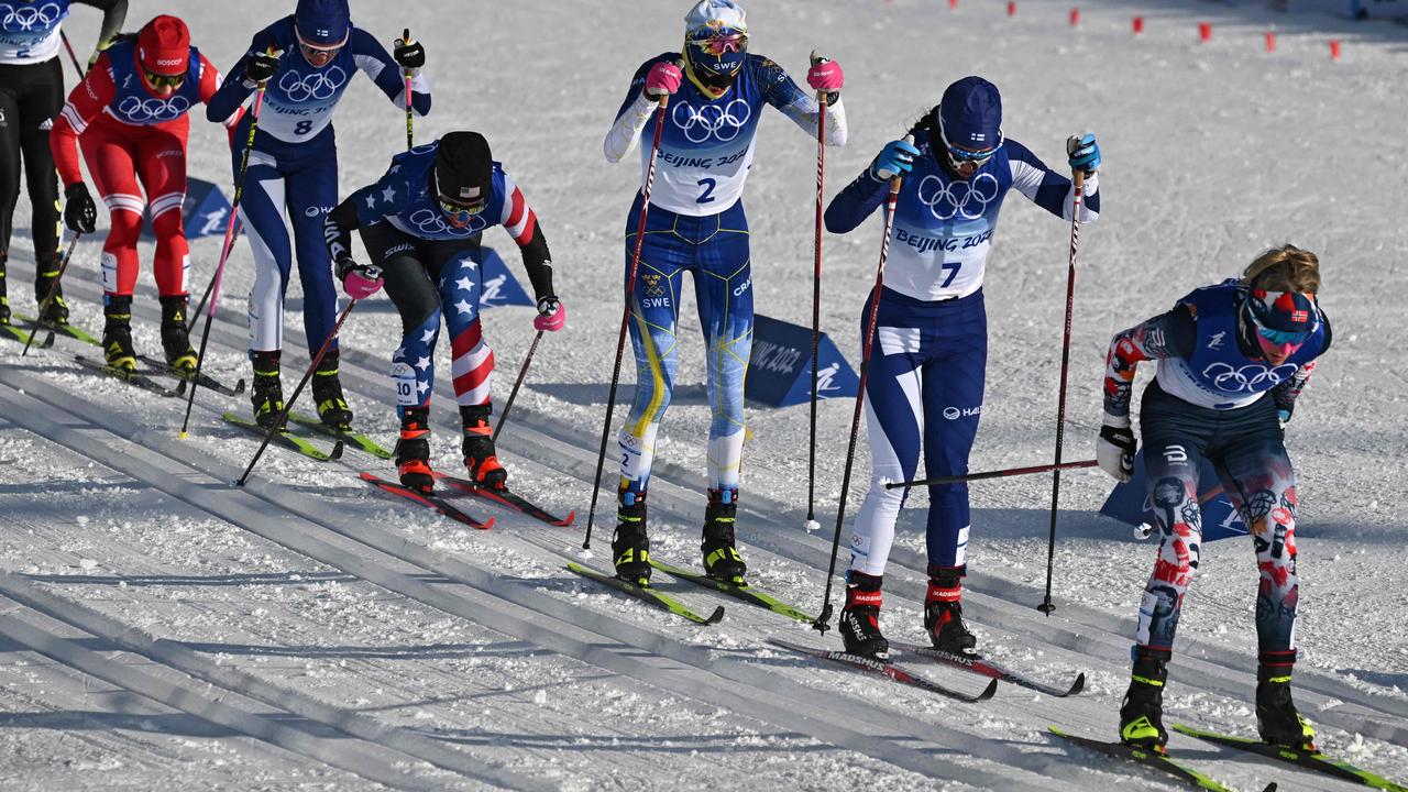 Norway's Therese Johaug (R) competes with Finland's Krista Parmakoski (2R) and Sweden's Frida Karlsson (3R) as she leads the women's skiathlon 2x7,5km event during the Beijing 2022 Winter Olympic Games on February 5, 2022, at the Zhangjiakou National Cross-Country Skiing Centre. (Photo by Jewel SAMAD / AFP)