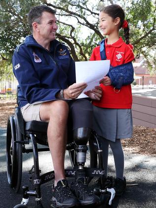 Garry Robinson with Beatrice Shimada, 9, who has written a letter to encourage the athletes. Picture: David Swift