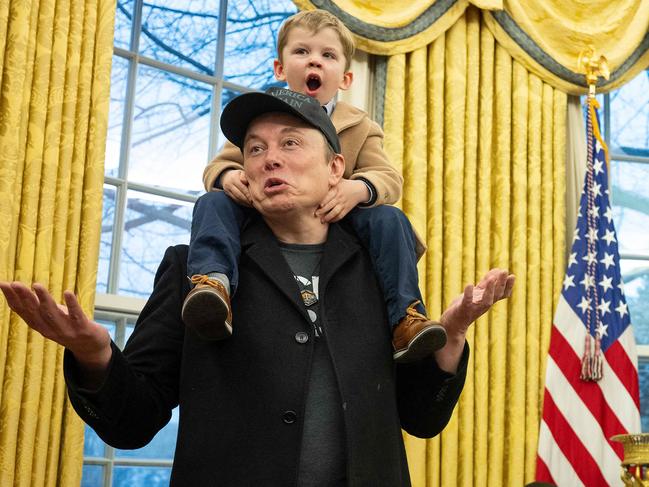 Tesla and SpaceX CEO Elon Musk with his son X Ã A-Xii join US President Donald Trump as he signs executive orders in the Oval Office of the White House in Washington, DC, February 11, 2025. DOnald Trump signs order handing Musk and DOGE more power to slash federal workforce. The new executive order forbids agencies from hiring more than one new worker for every four who leave government service. (Photo by Jim WATSON / AFP)