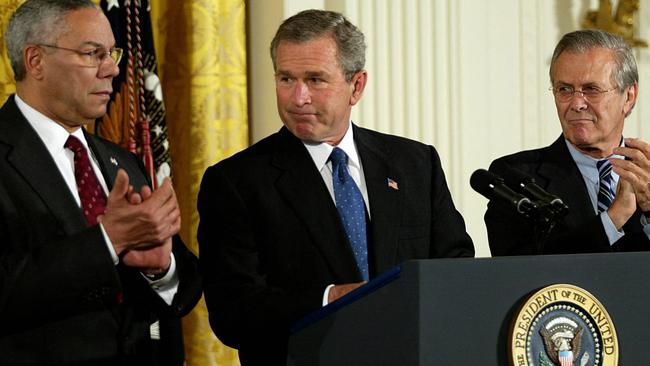 Colin Powell with George W .Bush and former Secretary of Defence Donald Rumsfeld (R) in the East Room of the White House in 2003. Picture: AFP.