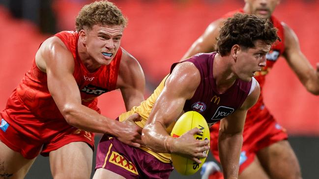 GOLD COAST, AUSTRALIA - FEBRUARY 20: Jarrod Berry of the Lions is tackled by Jed Walter of the Suns during the 2025 AFL Match Simulation between Brisbane Lions and the Gold Coast Suns at People First Stadium on February 20, 2025 in the Gold Coast, Australia. (Photo by Russell Freeman/AFL Photos via Getty Images)