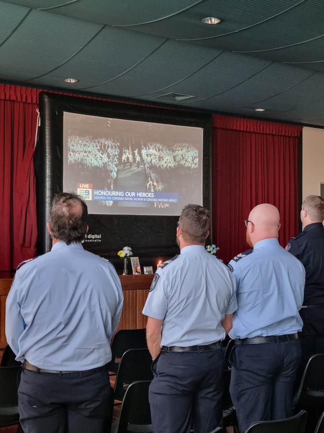 Queensland Police officers in the Tara Memorial Hall to watch the livestream of the Brisbane-based funeral for Tara Constables Rachel McCrow and Matthew Arnold.