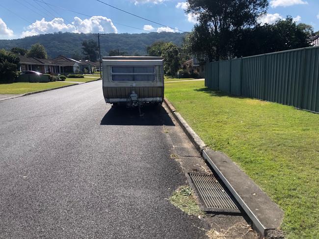 Bailey was found on the nature strip beside this caravan on Benelong Close, Kincumber with a 5cm puncture wound. Picture: Richard Noone