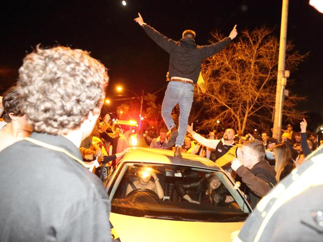 A Richmond fan runs on to a car. Picture: Patrick Herve