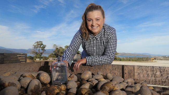 Ruby Daly with Hellfire Vodka made from potatoes on her family's farm. Pictures: LUKE BOWDEN