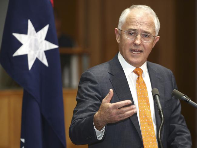 Prime Minister Malcolm Turnbull holds his hand out as he speaks to the media during a press conference at Parliament House in Canberra, Australia, Sunday, May 8, 2016. Turnbull officially announced a double dissolution election on July 2, 2016 and put economic management at the forefront of his campaign to win a second three-year term for his conservative coalition during era of extraordinary volatility in Australian politics. (AP Photo/Rob Griffith)