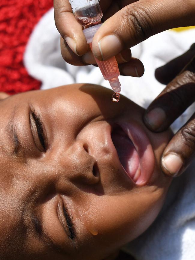 A community health worker delivers a polio vaccine to a child in Kiamako, Nairobi on July 19, 2021. Picture: Simon Maina/AFP