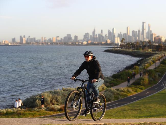 MELBOURNE, AUSTRALIA - APRIL 21: Darren Rutherford rides his bike at Elwood Beach on April 20, 2020 in Melbourne, Australia. A sudden increase in online and in store bicycles and equipment along with cycling via online platforms has seen an unplanned affect on the cycling industry as a result of the Covid-19 pandemic. Cycling is permitted under strict isolation policies due to its natural state of distancing.  (Photo by Robert Cianflone/Getty Images)