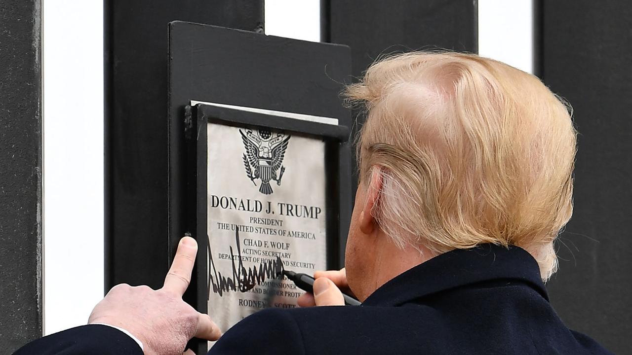 ‘Totally appropriate’: Donald Trump leaves his mark on the border wall with Mexico in Alamo, Texas, on Wednesday. Picture: AFP