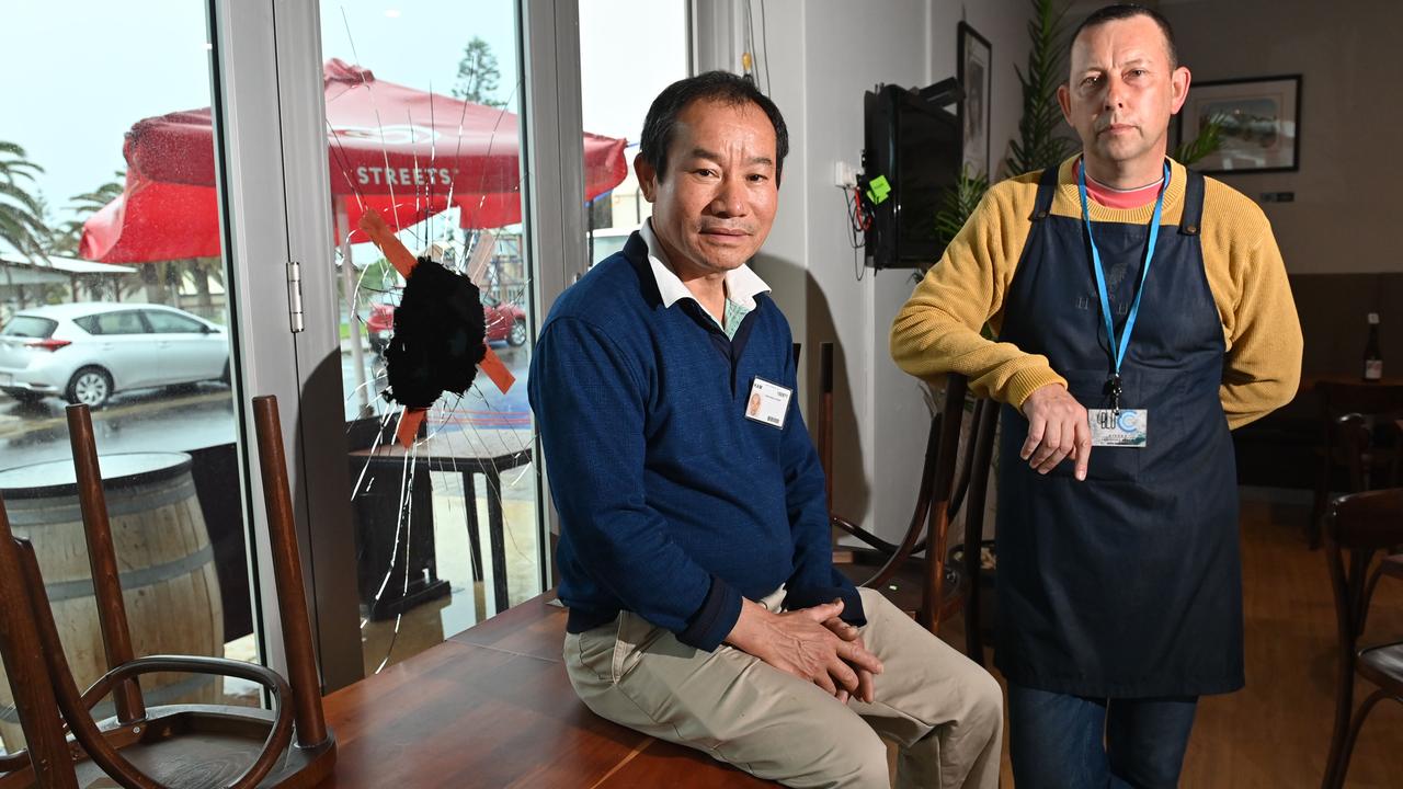 Over a dozen shop fronts were smashed overnight along Beach Road and the Esplanade at Christies Beach – Blu C Cafe owner Kam Ng Shung with Manager Martin Orchard. Picture: Keryn Stevens