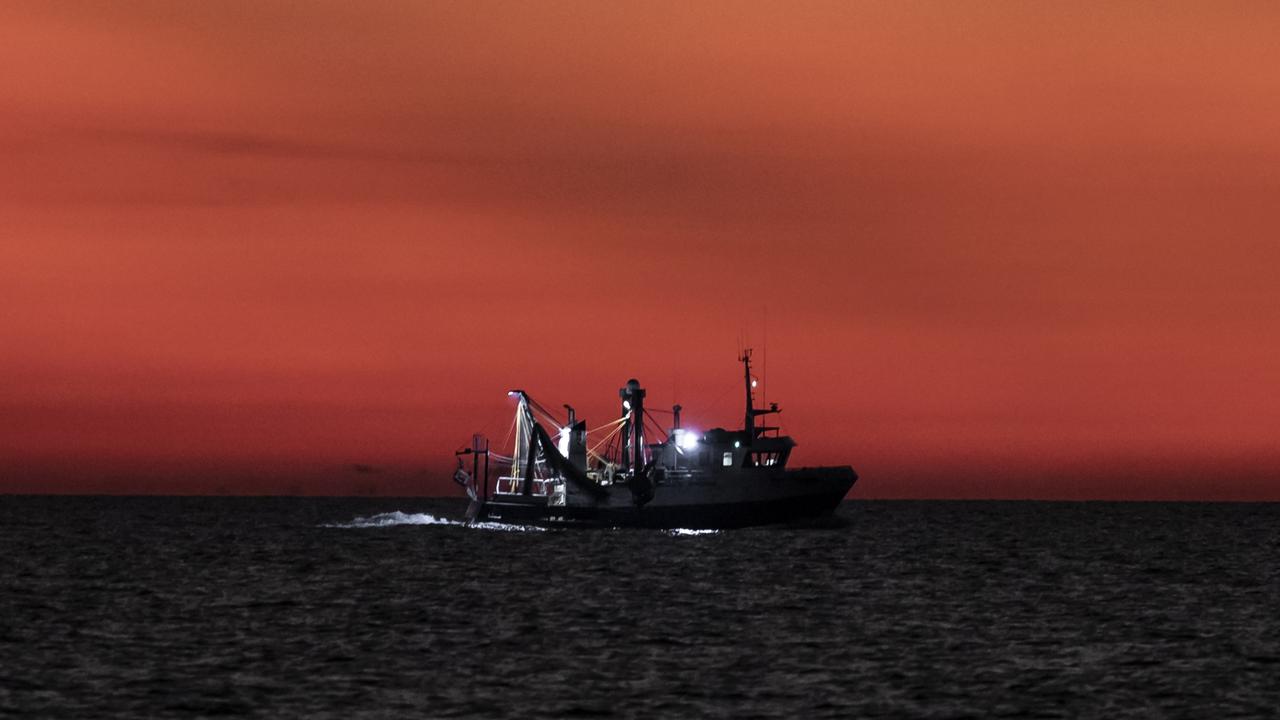 A fishing trawler passes the LCM-8 as the sun sets. Picture: Dylan Robinson