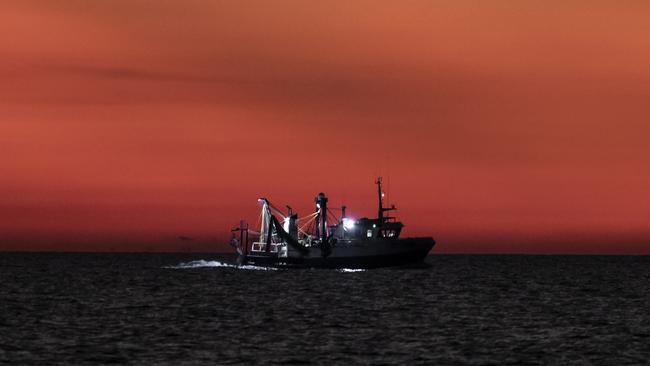 A fishing trawler passes the LCM-8 as the sun sets. Picture: Dylan Robinson