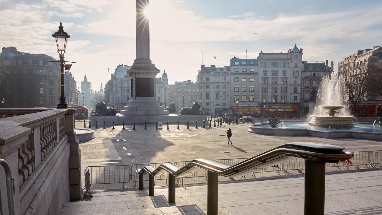 A lone woman takes a picture in a deserted Trafalgar Square. For the third time, England was asked by PM Boris Johnson to remain at home for a nationwide lockdown due to a spike in cases across the country. A new high of 60,000 were reported in a single day. Picture: Alex McBride/Getty Images