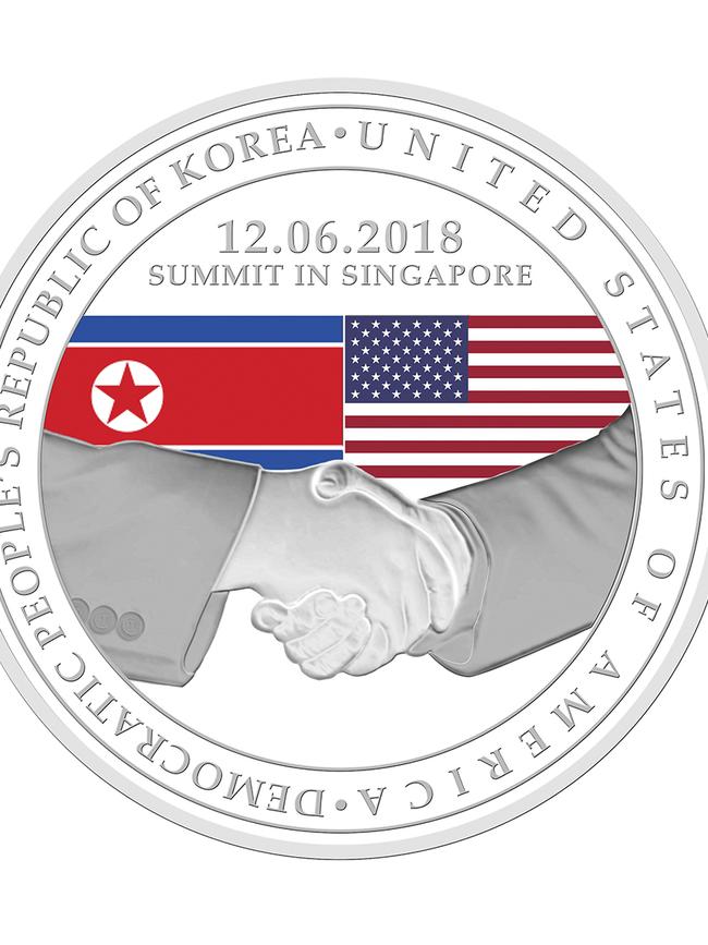 The design of a silver-plated commemorative medallion depicting a handshake with images of the US and North Korean national flags. Picture: AFP/The Singapore Mint