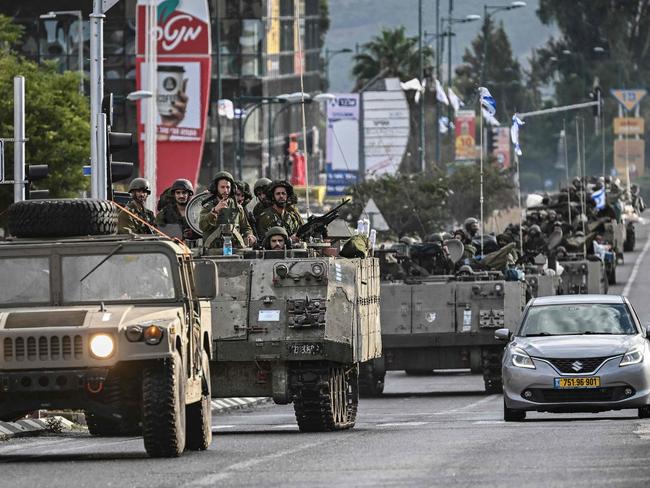 Israeli soldiers patrol in armoured personnel carriers at an undisclosed position in northern Israel near the borer with Lebanon. Picture: AFP