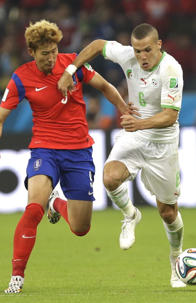 Fierce competition in Group H … South Korea's Son Heung-Min battles Algeria's Djamel Mesbah for the ball. Picture: AP Photo/Fernando Vergara