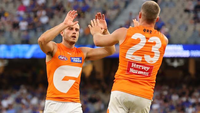 Xavier O'Halloran high fives Jesse Hogan after a goal. Picture: James Worsfold/AFL Photos/via Getty Images