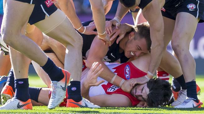 Carlton skipper Patrick Cripps lays a strong tackle on George Hewett. Picture: AAP