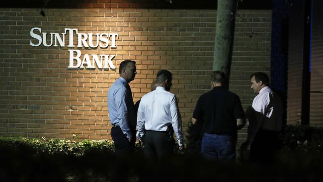 Law enforcement officials investigate the scene where at least five people were killed at a SunTrust Bank branch. Picture: Joe Raedle/Getty/AFP 