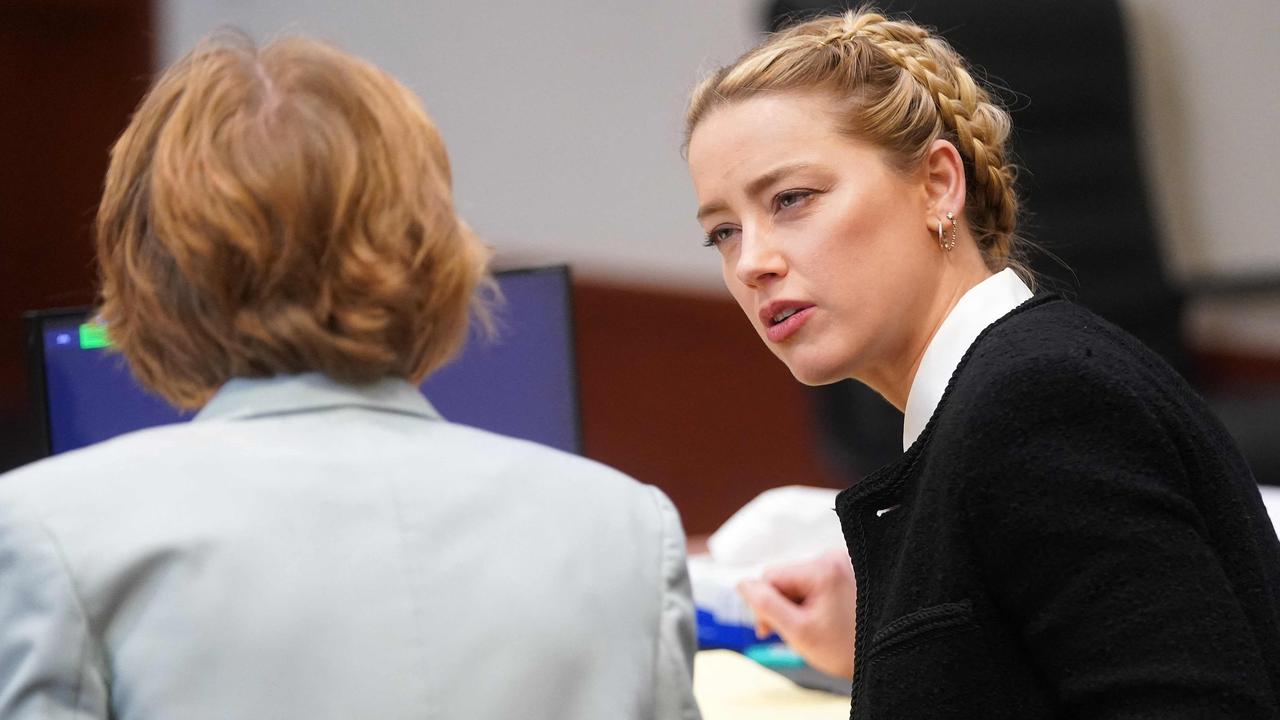 Amber Heard confers with her legal team. (Photo by Shawn THEW / POOL / AFP)