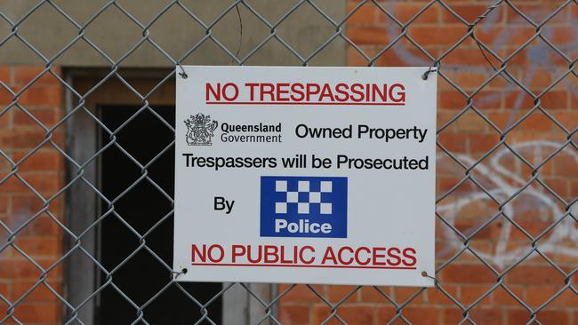 A sign posted on the fence at the old asylum.