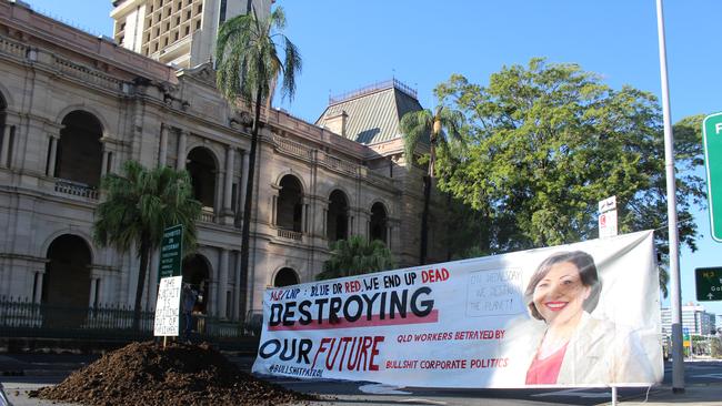 A banner featuring a picture of Jackie Trad was placed near a pile of manure dropped outside Parliament House by Extinction Rebellion activists. Picture: Nathan Edwards