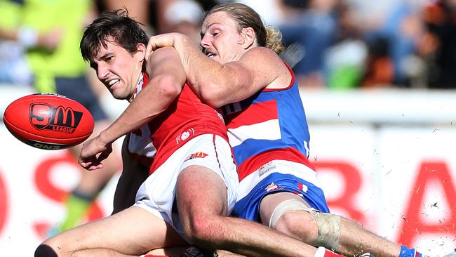 Tom Schwarz of North Adelaide handballs under pressure from Central’s Nicholas Holman, at Prospect Oval last season. Picture: Stephen Laffer