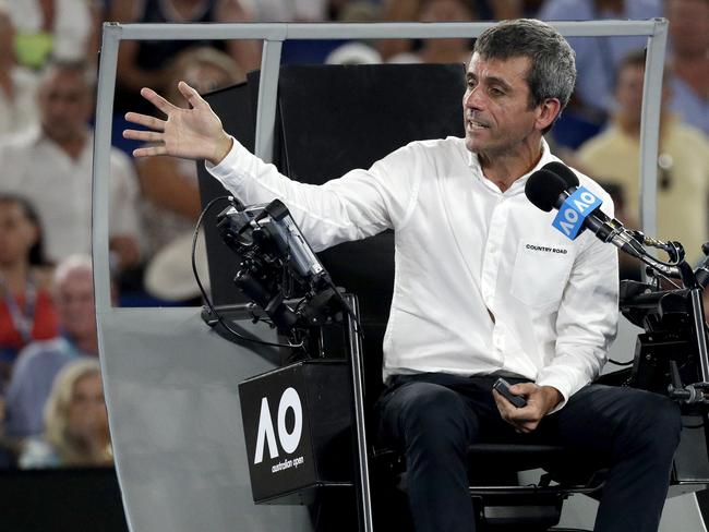 Chair umpire Carlos Ramos gestures as he explains the call to Danielle Collins. Picture: AP