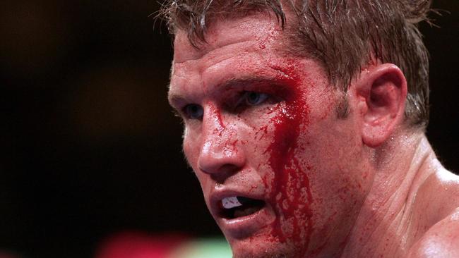 p43briggsy21/05/2005. Paul Briggs of Australia with blood oozing from his left eyebrow looks on during his fight against Tomasz Adamek. AFP PHOTO/JEFF HAYNES.