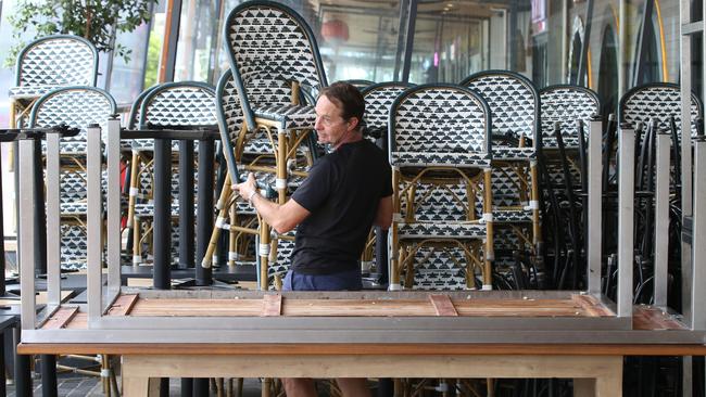 Businesses shut down in Broadbeach due to the new Coronavirus regulations. Madison’s staff member Stephen Condon packs up. Picture Glenn Hampson