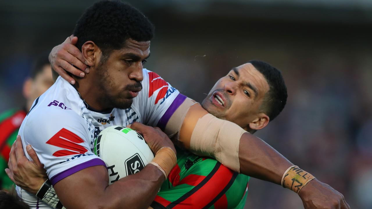 Tui Kamikamica of the Melbourne Storm is tackled by Cody Walker of the South Sydney Rabbitohs.