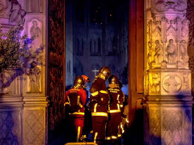 Firefighters are seen inside famed Notre-Dame Cathedral assessing the damage caused by fire on April 15, 2019 in Paris, France. Photo by Omar Havana / Getty Images